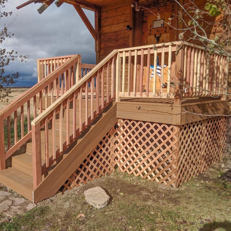 Achieve the perfect blend of rustic charm and modern durability with this custom DeckPro LLC project. We paired low-maintenance brown composite decking with natural wood railings and matching lattice skirting to seamlessly complement the style of this country cabin.