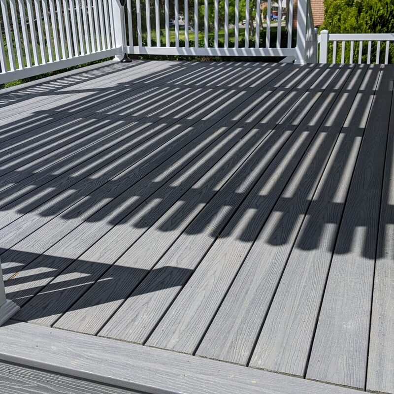 Expand your outdoor living possibilities with this custom composite deck and pergola combination by DeckPro LLC, which combines rustic elements with modern materials. We installed low-maintenance grey composite decking and paired it with a unique louvered pergola system featuring natural wood posts. For the ultimate in functional design, this louvered roof offers customizable shade, creating a cozy and inviting retreat.