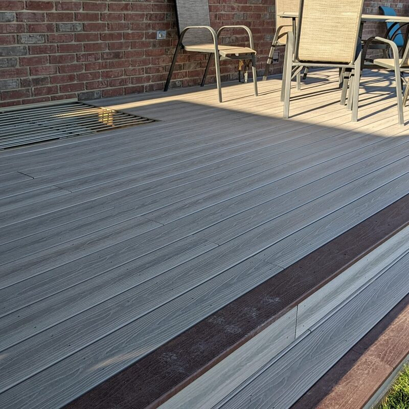 Extend your outdoor living possibilities with this custom deck by DeckPro LLC, which combines rustic elements with modern materials. This design provides a sturdy and stylish retreat, even in snowy conditions, utilizing durable, low-maintenance composite materials. The unique railing system transitions seamlessly from natural wood posts to an elegant hog wire / wire mesh infill. For the ultimate in functional design, we included extensive built-in L-shaped bench seating, creating a cozy perimeter perfect for relaxing or taking in scenic views.