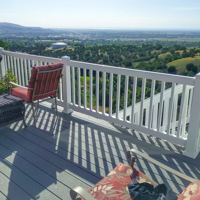 Enjoy breathtaking scenery from your own backyard. This custom composite deck by DeckPro LLC features durable, low-maintenance materials and clean white vinyl railing designed to maximize the stunning views of the Snake River Valley.