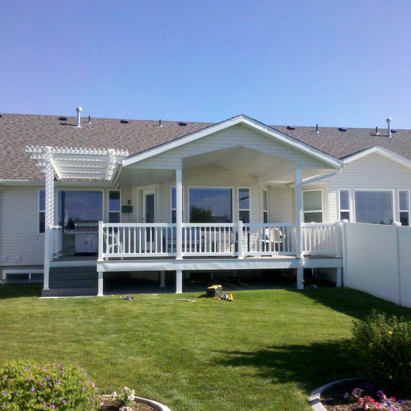Get the best of both worlds with this custom DeckPro LLC project in Rexburg. This beautiful white deck features a solid gabled patio cover for complete shade and rain protection, seamlessly integrated with an attached pergola for filtered sunlight and style.