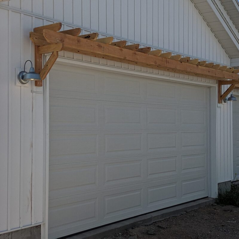Extend your multi-level outdoor living with this expansive composite deck by DeckPro LLC, pictured here in a transition from winter to spring. We installed high-quality, low-maintenance composite decking and paired it with safe and sophisticated dark perimeter railings to ensure safety without obstructing views. Pictured on a beautiful sunny day with distinct railing shadows cast across the boards, the structure transitions through massive, wide staircases to a concrete lower patio pad, all transitioning into a large grassy yard. Recessed lights in the under-deck ceiling allow for extended evening use. Direct access via existing sliding glass doors makes indoor-outdoor living effortless.