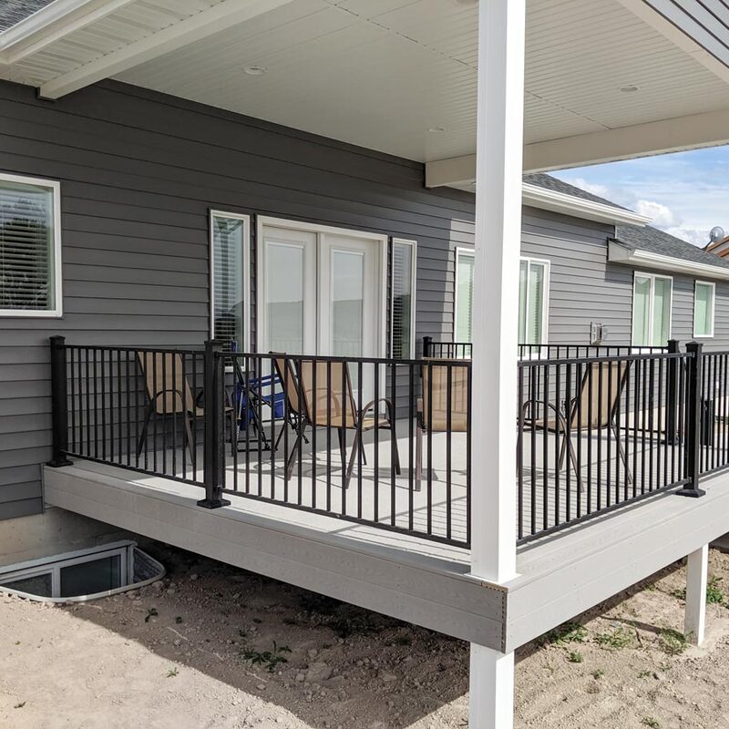 Transform your elevated outdoor living space with "The Prairie Plateau," a premium all-weather covered composite deck installation by the specialists at DeckPro LLC. This stunning project seamlessly attaches a modern covered patio design directly to a dark grey sided home, creating a sophisticated retreat for dining and social gatherings.