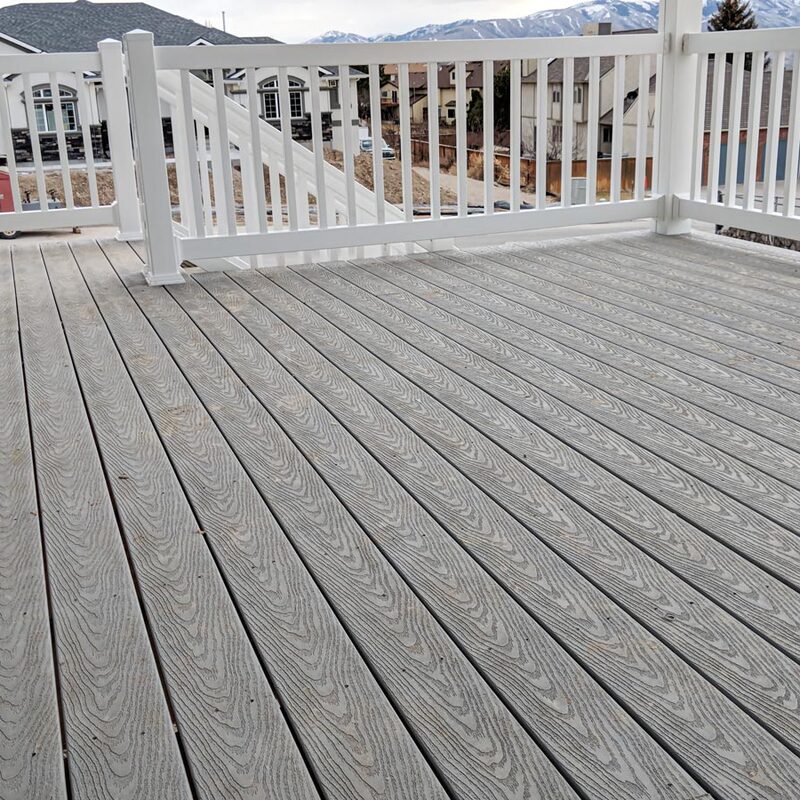 This stunning photograph showcases the beauty and durability of our premium composite decking. The weathered grey finish perfectly captures the rustic charm of aged wood, while the composite material offers exceptional resistance to rot, mold, and insect damage.