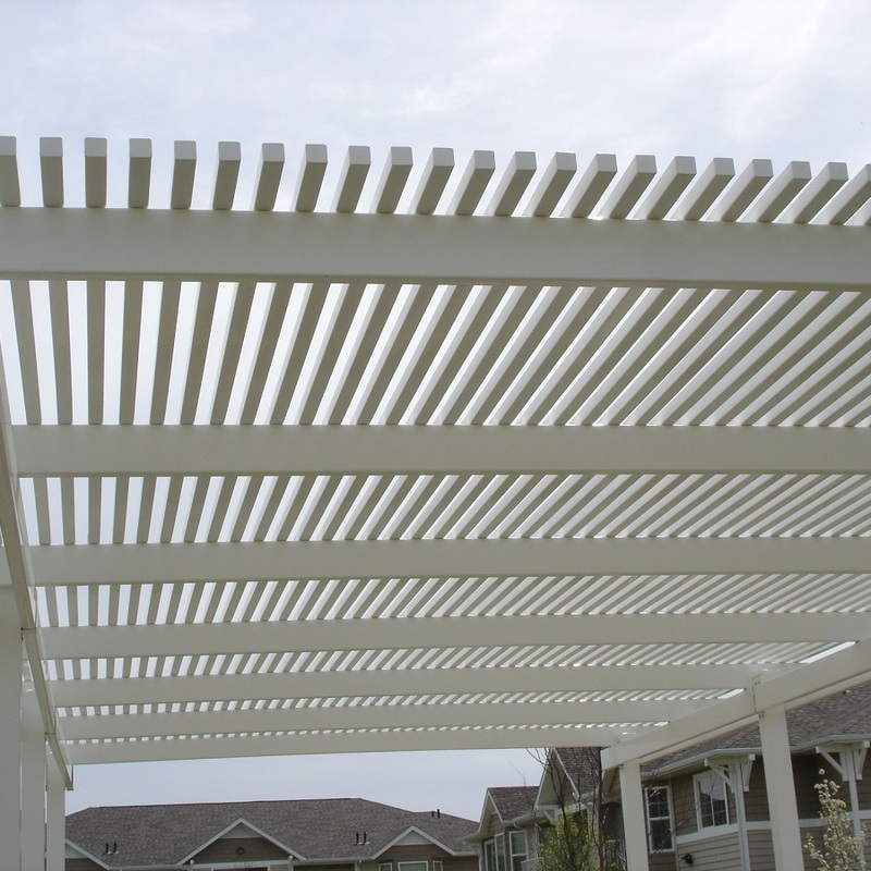 Experience unprecedented sun and shade control with the DeckPro Custom Adjustable Louvered Pergola Roof System. This dynamic, low-angle close-up view highlights the stunning geometric patterns created by the massive, white, custom multi-bay louvered pergola roof. Engineered with substantial columns and beams, the system features multiple independent panels of adjustable louvers, allowing you to effortlessly fine-tune sunlight, ventilation, and even rain protection.