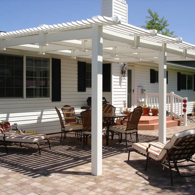 Extend your multi-level outdoor living with this custom elevated composite deck transformation by DeckPro LLC. Pictured on a beautiful sunny day, this functional retreat features grey wood-grain planks paired with safe and sophisticated white railings with vertical balusters. A custom louvered pergola provides adjustable shade, while integrated rock garden landscaping below the sturdy raised structure defines defined defined zones perfect for both relaxation and large-scale entertaining under prominent prominent covered covered upper upper area. effortless flow is ensures afternoon use.