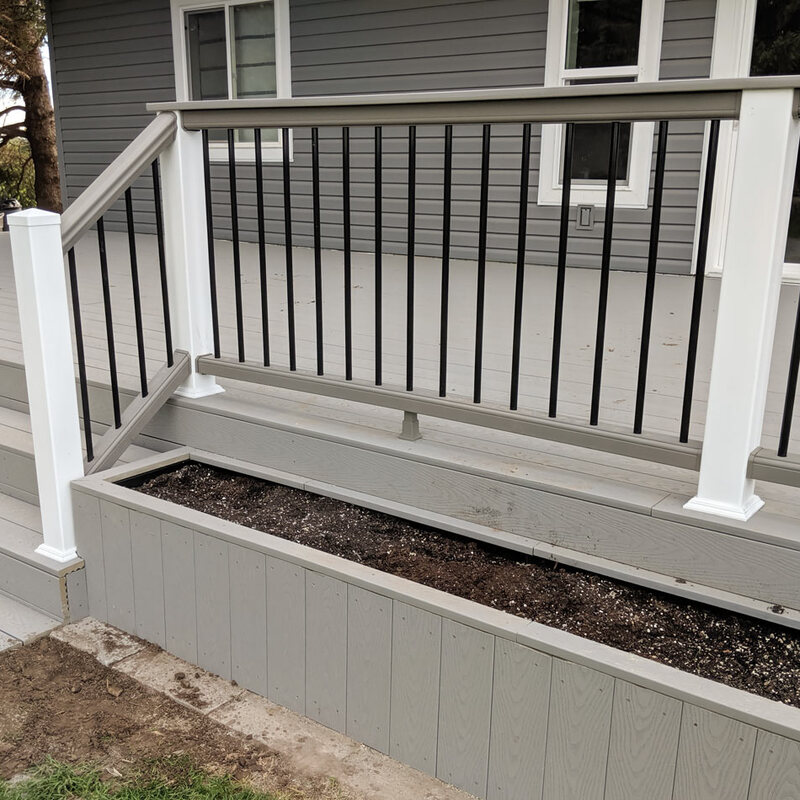 Add a touch of nature directly to your deck design with a custom built-in planter from DeckPro LLC. This project features low-maintenance grey composite decking and an integrated planter box, ready for your favorite flowers or herbs.