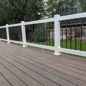 back yard deck with black and white railing