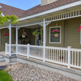 front porch with decorative white rails.