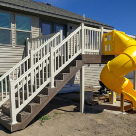 back deck with yellow slide attached.