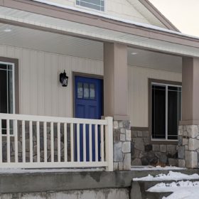 blue door with tan porch rails.