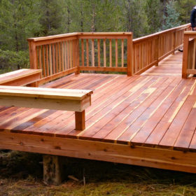 red wood deck in forested area.