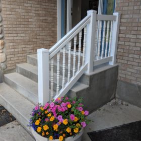 small porch with white hand rail.
